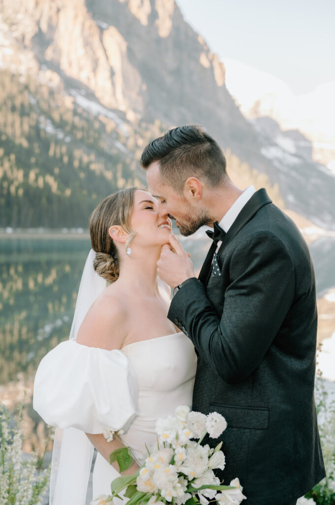 bride-and-groom-almost-kissing-close-up-styled-lake-louise-wedding-with-mountain-backdrop-banff-wedding-photography