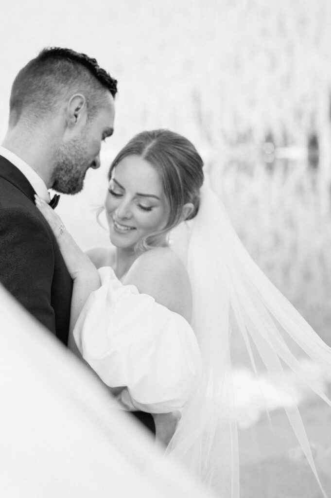black-and-white-romantic-portrait-bride-and-groom-embracing-styled-lake-louise-wedding-banff-wedding-photography